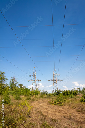 High voltage electrical lines and equipment against the blue sky.