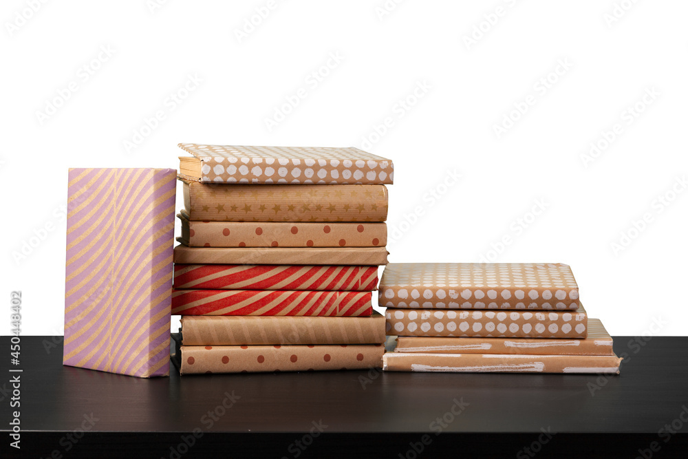 Stack of books on wooden table against white background Stack of books on wooden table against white background