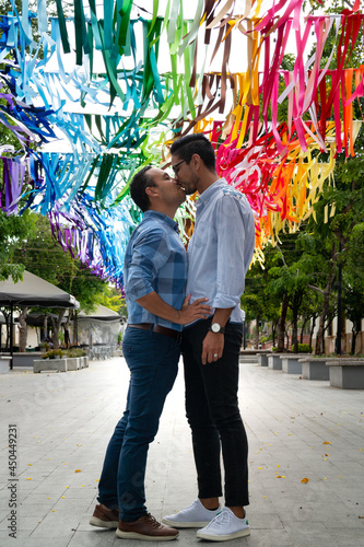 gay couple of latin men in love walking in the city of zapopan jalisco, gay concept photo