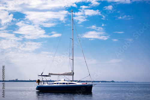 yacht on the water against the blue sky with clouds