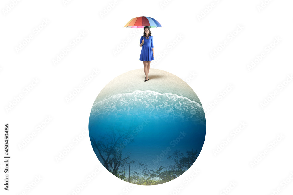 Asian woman standing with an umbrella on the beach Asian woman standing with an umbrella on the beach