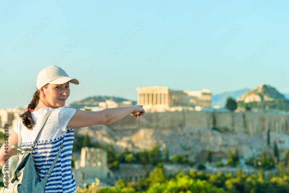 Enjoying vacation in Greece. Young traveling woman enjoying view of Athens city and Acropolis.