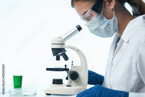 female doctor laboratory research microscope biotechnology professional