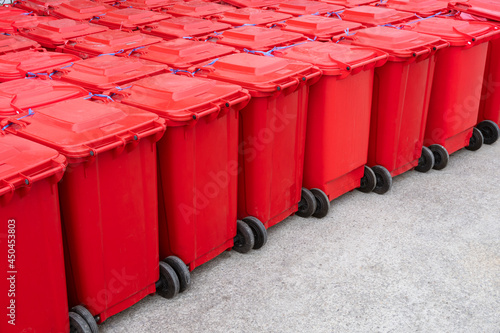 Rows of red hazardous waste bins are neatly packed with rubbish from COVID-19 patients behind the field hospital between waiting to be dispose hygienically photo