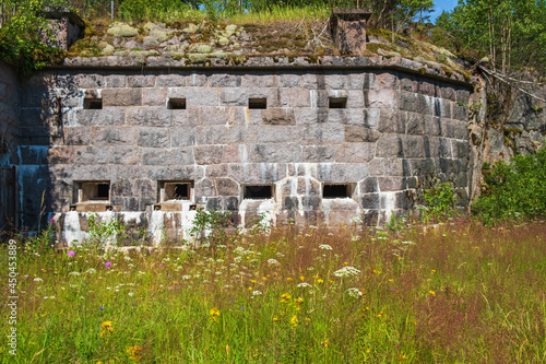 Fortified wall in a moat with a flowering meadow
