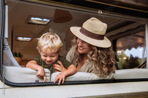 Canvas Print Parent and child in camper van spend time together playing and laughing