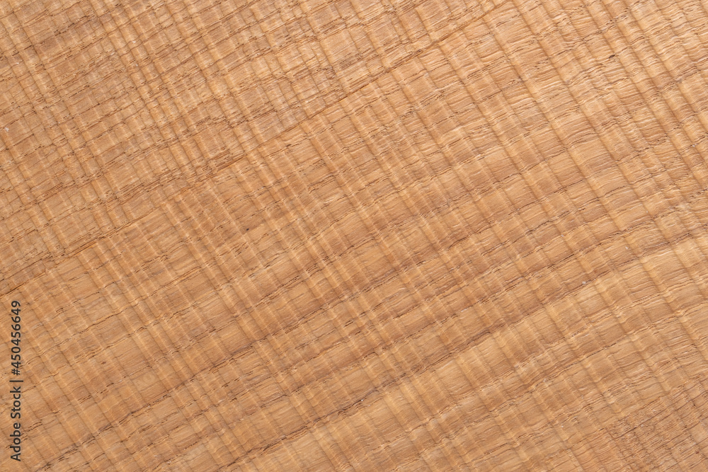 Textured wooden plank with a weathered cracked surface Textured wooden plank with a weathered cracked surface