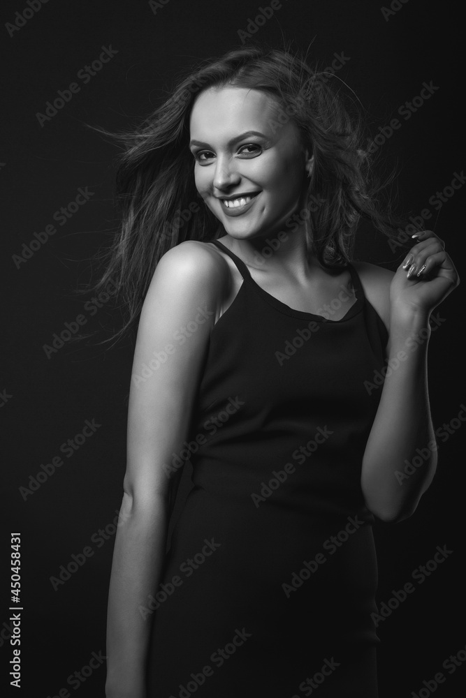 Stylish studio portrait of a happy brunette woman with perfect makeup
