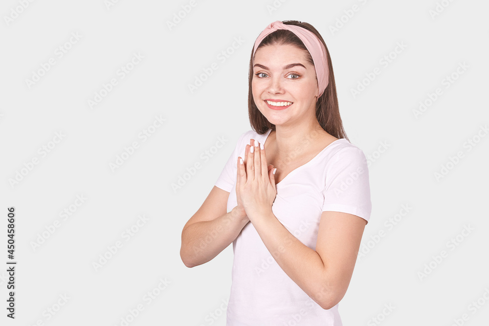Pretty young woman gesture. Studio portrait. Female person. Isolated background. Morning bathroom routine. Pray pose. Happy medication emotion. Fitness practice. Hand yoga mudra Pretty young woman gesture. Studio portrait. Female person. Isolated background. Morning bathroom routine. Pray pose. Happy medication emotion. Fitness practice. Hand yoga mudra
