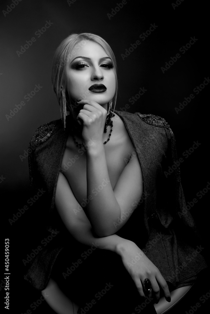 Stylish studio shot of a glamorous lady wears jacket on a naked body Stylish studio shot of a glamorous lady wears jacket on a naked body