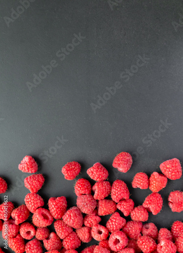Fresh and sweet raspberry in a dark background. Top view