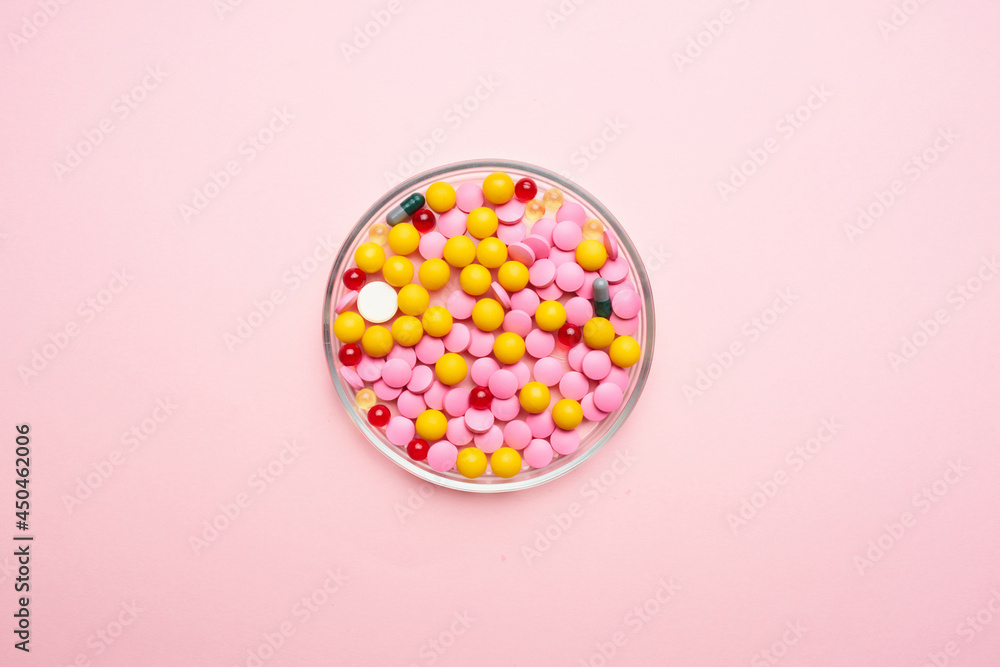 medicine colorful plates pink background close-up antibiotics