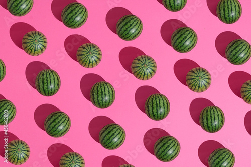 Watermelons lay down on a pastel pink background, pattern summer concept