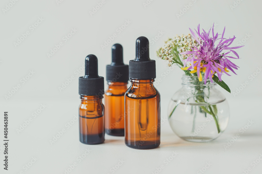 Brown glass bottle with serum, essential oil or other cosmetic product. Skin care concept. Brown glass bottle with serum, essential oil or other cosmetic product. Skin care concept.