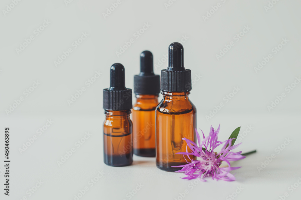 Brown glass bottle with serum, essential oil or other cosmetic product. Skin care concept. Brown glass bottle with serum, essential oil or other cosmetic product. Skin care concept.