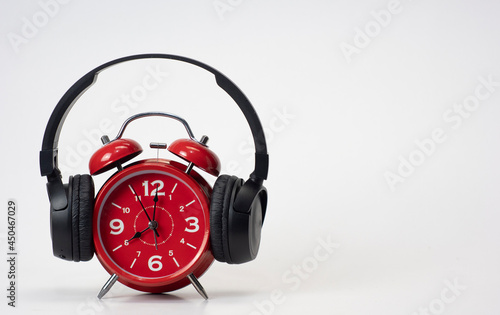 Red Alarm Clock put on headphones