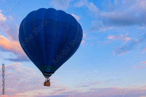 Balloon Festival Montgolfier, close-up of a bright blue hot air balloon in the air against a blue sky with beautiful pink clouds at sunset, backgrounds, wallpapers,  there is copy space in the foto
