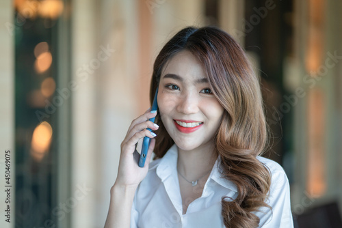 Beautiful of portrait young asian woman talk smart phone and smile