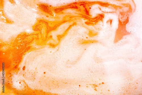 Foam after dissolving color bath bomb in water. Suds texture