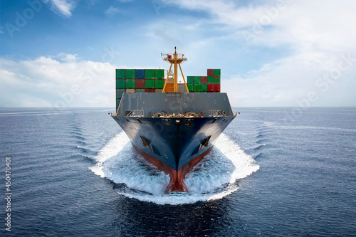 Wallpaper Mural Front view of a loaded container cargo vessel traveling with speed over blue oce