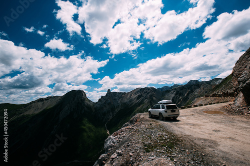 Driving off road car on high altitude mountain top