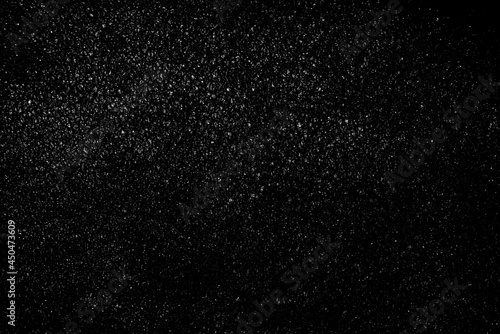 Falling snow on a black background. small particles with bright dots starry sky. Сhaotic white bokeh. light spots texture. abstract. © Илья Подопригоров