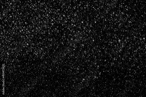 Falling snow on a black background. small particles with bright dots starry sky. Сhaotic white bokeh. light spots texture. abstract.