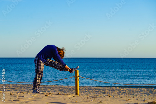 Woman exercising on beach at morning. photo