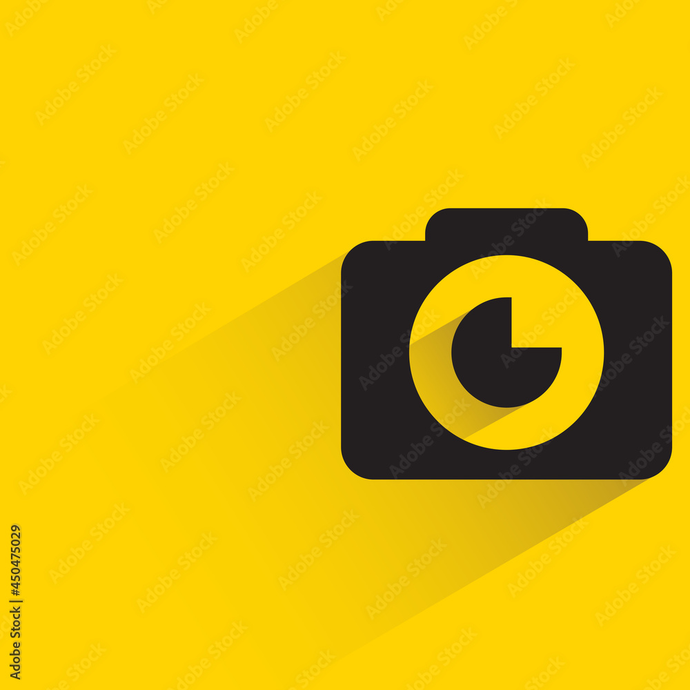 digital camera with shadow on yellow background digital camera with shadow on yellow background