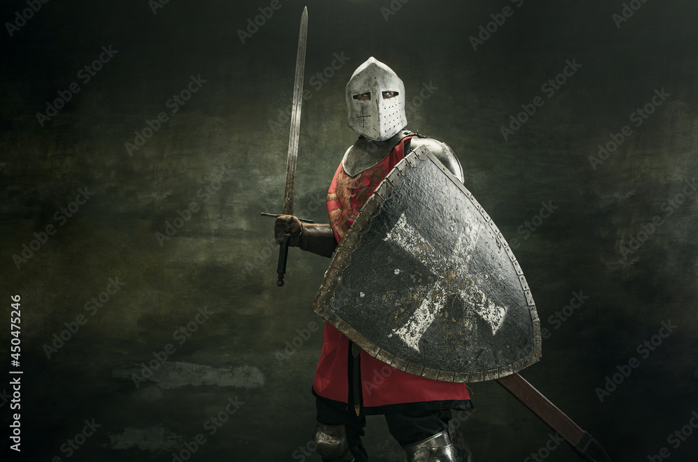 One medeival warrior or knight in armor and helmet with shield and sword - obrazy, fototapety, plakaty 