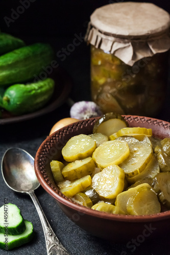 Pickled cucumber salad in a bowl and jar