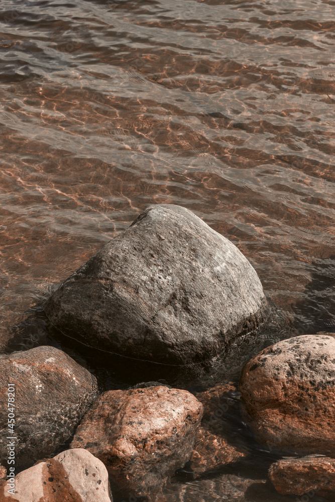Vertical background with large rocks and calm waters of the northern lake. Vertical background with large rocks and calm waters of the northern lake.