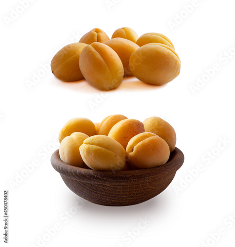 Heap of apricots isolated on white background. Ripe apricots with copy space for text. Apricots in a wooden bowl on white background.  Fresh summer fruits. Set of apricots.