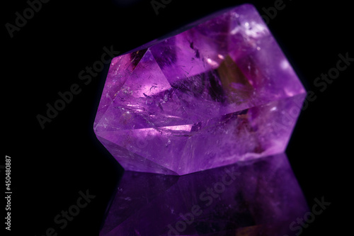 Macro mineral stone Amethyst crystal on a black background
