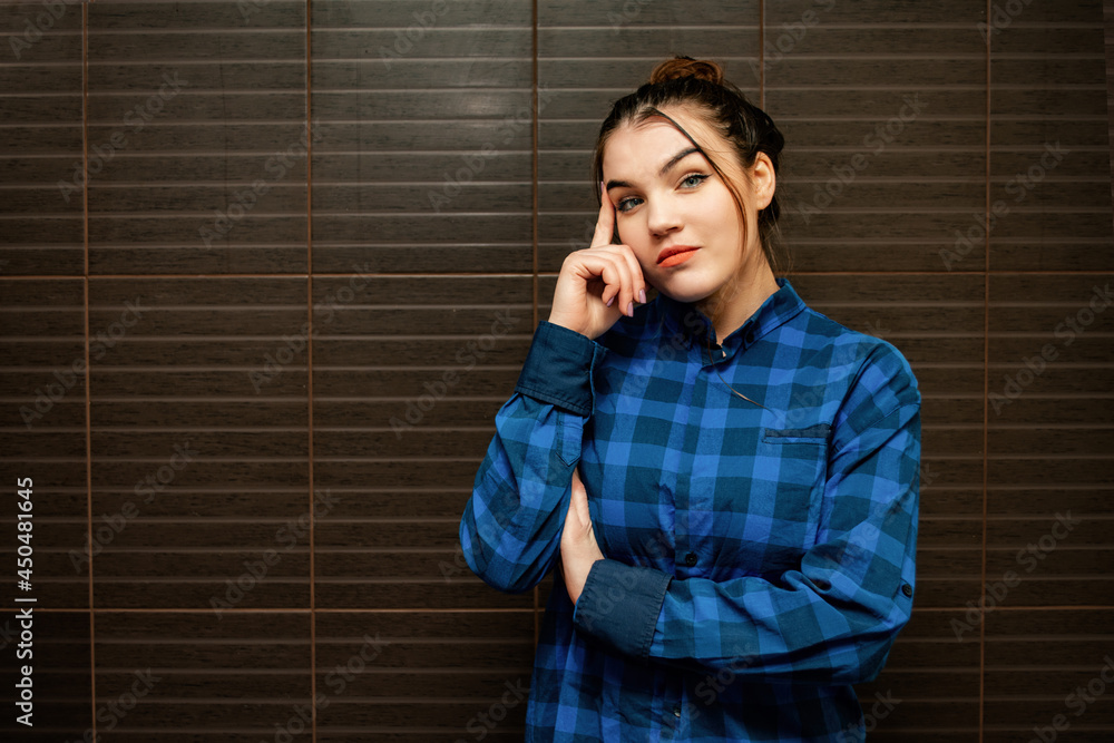 Young and beautiful woman pointing her finger to the side. Student and benefit. Young and beautiful woman pointing her finger to the side. Student and benefit.
