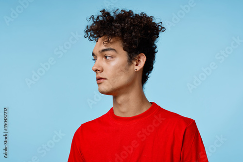 man in red t-shirt curly hair close-up lifestyle