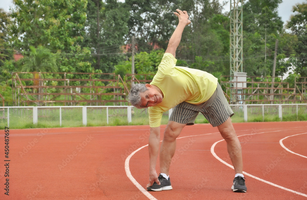 an old man warming up exercise before running or jogging, concept health care in elderly people