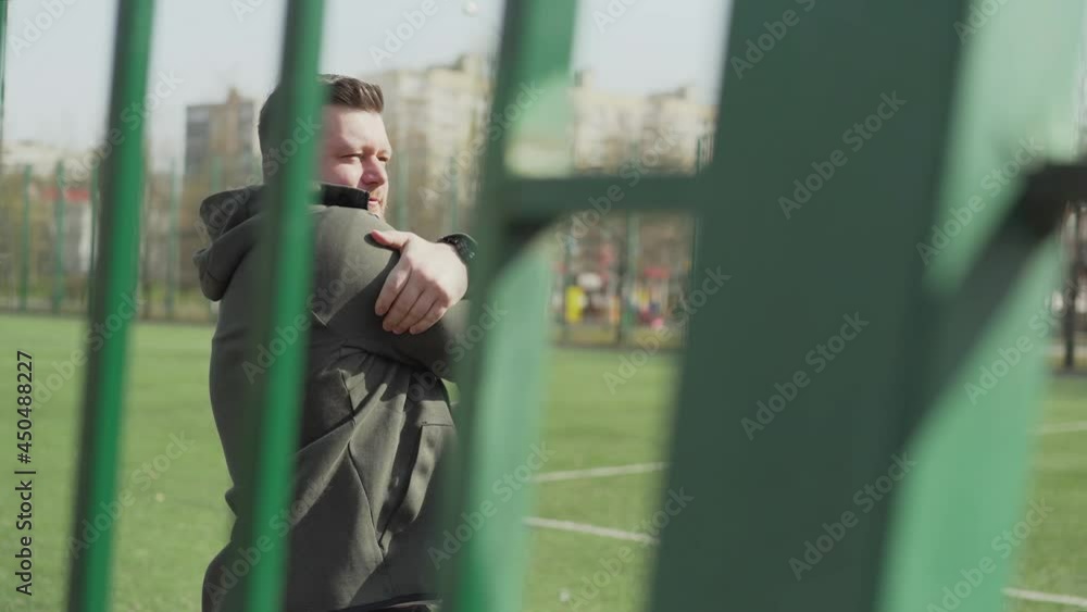 The man walks over to the playground. athlete concentrates on future workout, male athlete. The young man goes to the horizontal bar to pull himself up. The man walks over to the playground. athlete concentrates on future workout, male athlete. The young man goes to the horizontal bar to pull himself up.