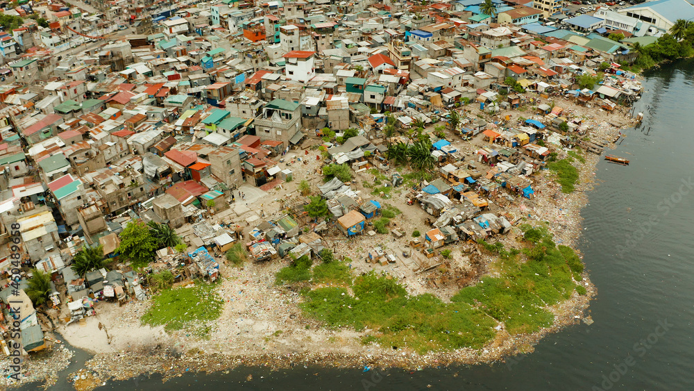 Slum area in Manila, Phillippines, top view. lot of garbage in the water.