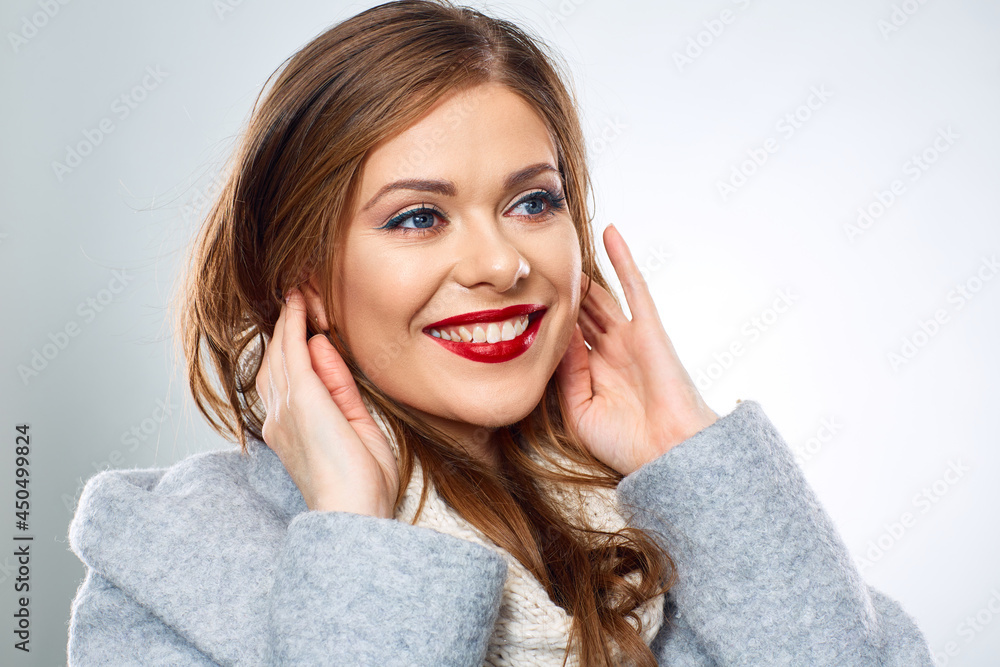 Close up face portrait of happy smiling woman wearing winter woolen coat Close up face portrait of happy smiling woman wearing winter woolen coat