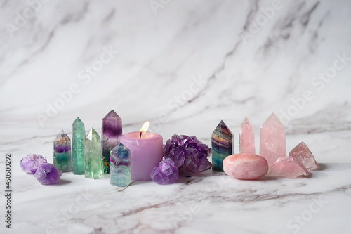 Gemstones minerals set and candle on marble background. Healing stones for Crystal Ritual, spiritual practice. modern magic. Esoteric life balance concept. Fluorite, amethyst, rose quartz