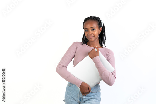 Student woman holding a laptop looking at camera. White background. African-Ethiopian black woman.