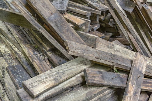 Heap of dirty wooden boards for the construction and improvement of the yard