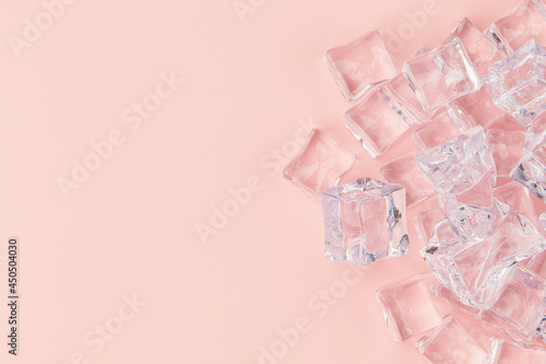 There are ice cubes on a pink background. © changju.kang