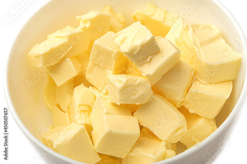 Fresh butter cubes close-up in a white bowl.