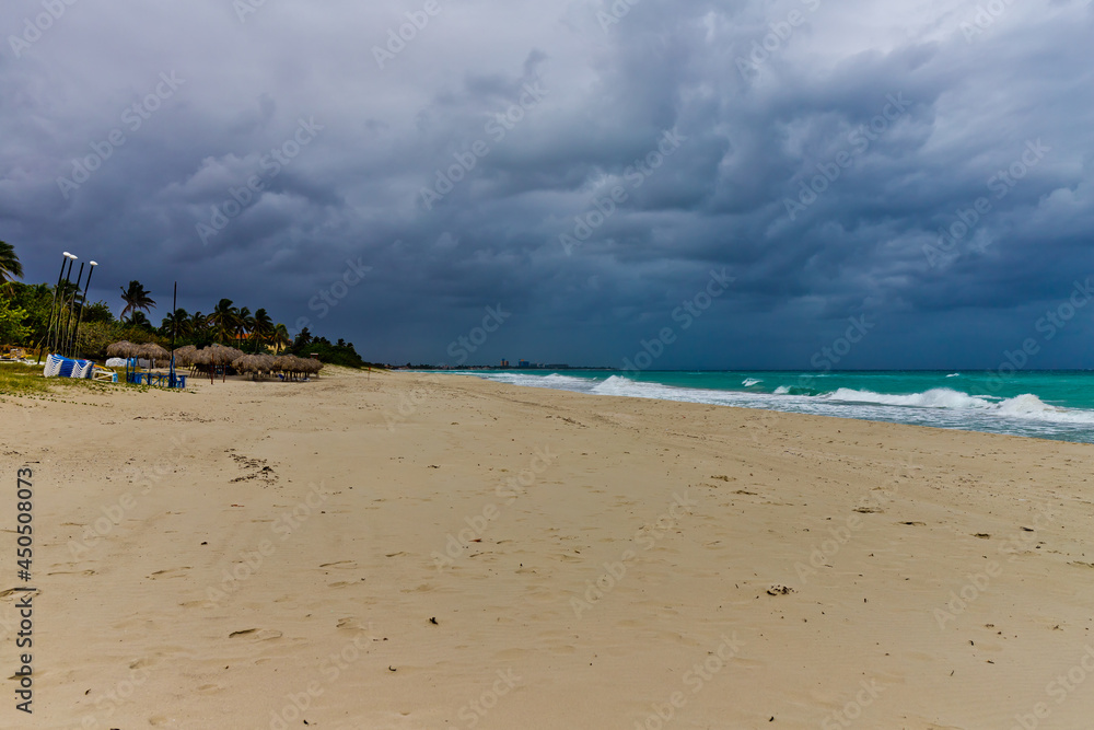 blue clouds and big waves during storm, empty beach blue clouds and big waves during storm, empty beach