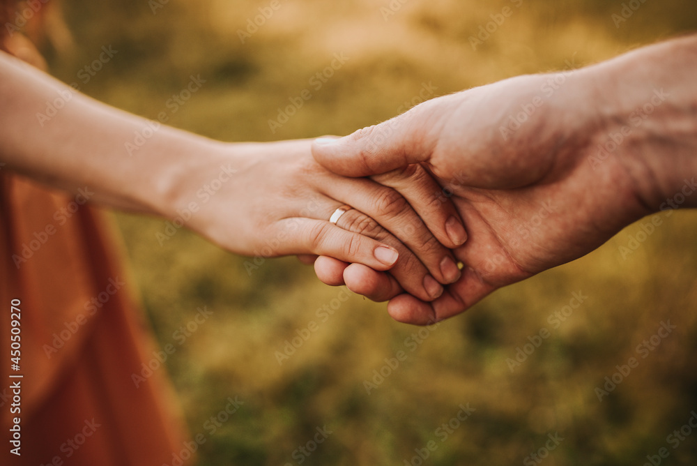 close up of couple holding hands close up of couple holding hands