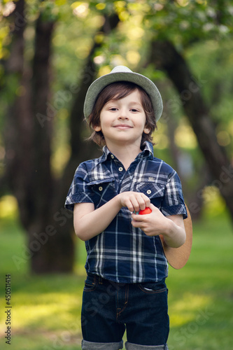 Portrait of cute little toddler boy . Beautiful male child with gorgeous brunette  hair playing alone outside on sunset time.
