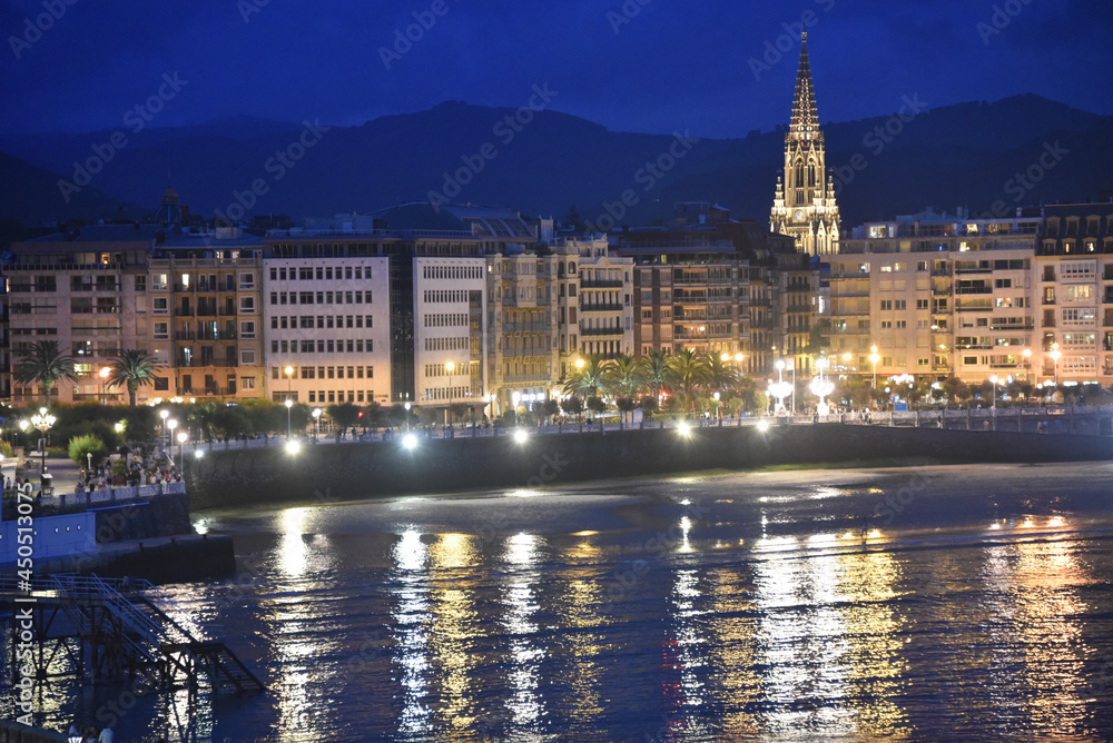 San Sebastian, Spain - 25 July 2021: Evening views of the Buen Pastor Cathedral and La Concha Bay