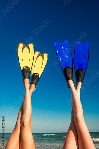 female legs shod in flippers raised up in summer